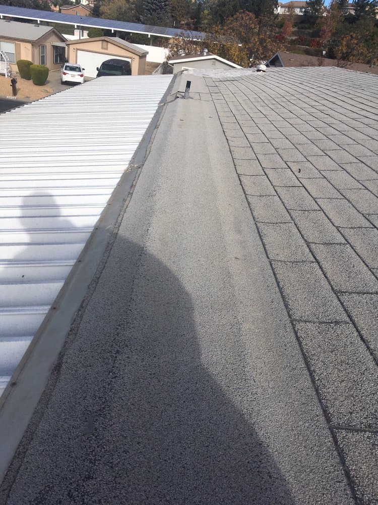 New ribbed metal roof beside a granulated flat roof section on a Sun City home