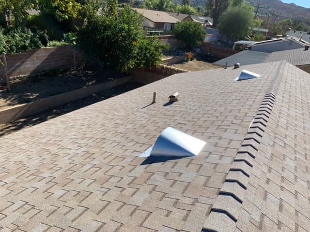 Finished architectural-shingle re-roof by Baker Roofing with new ridge and vents, Menifee valley